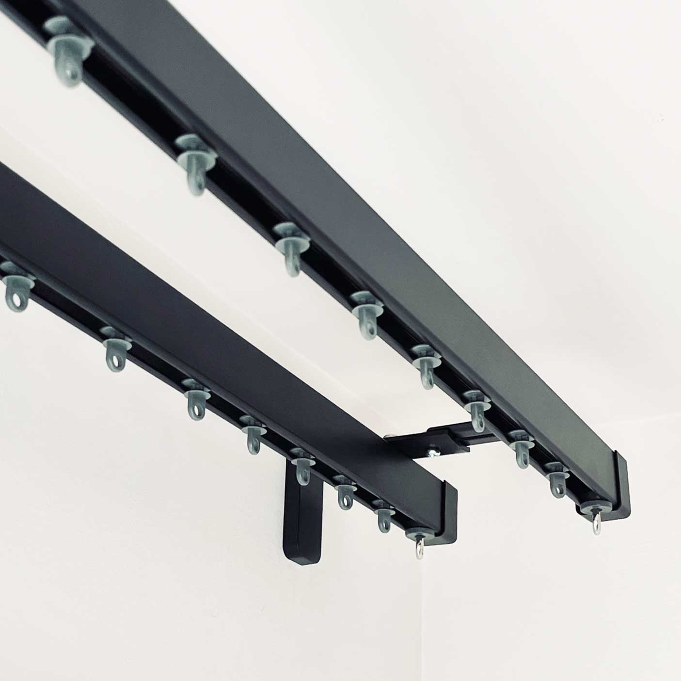 Detail of the Square30 double curtain track showing double bracket and gliders. 