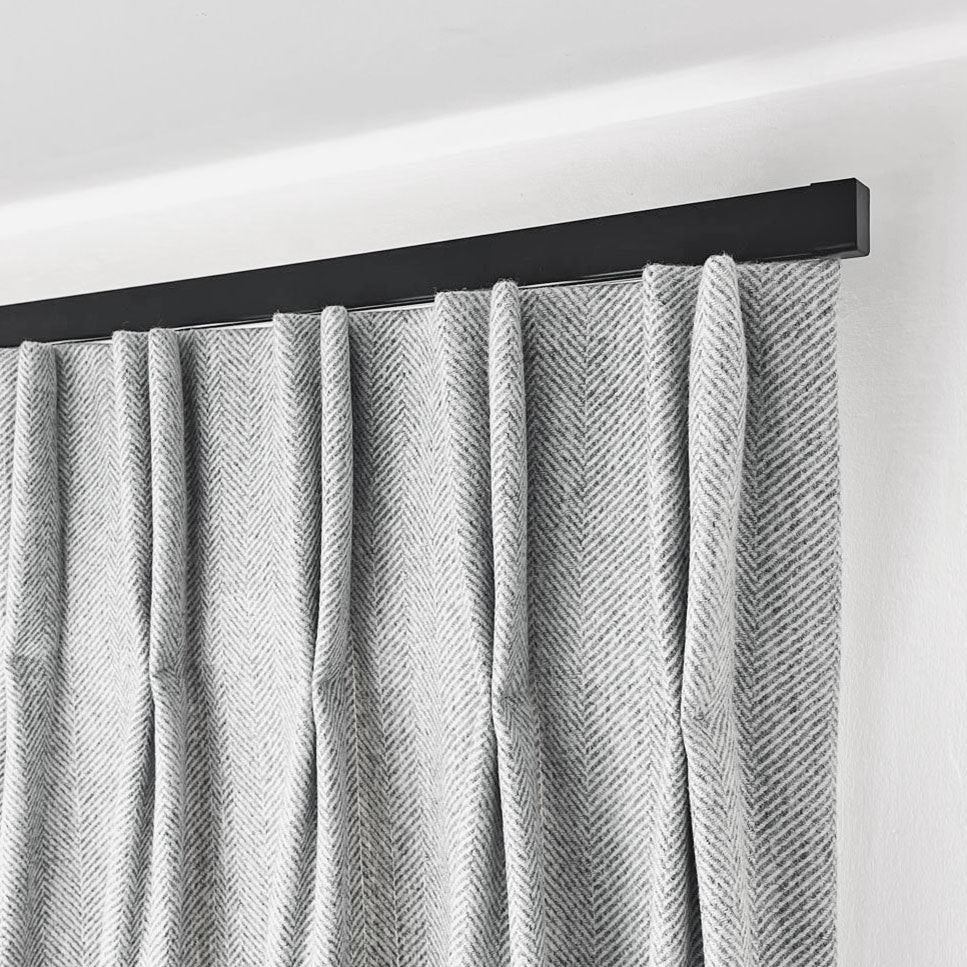 Black bendable curtain track with cap finials