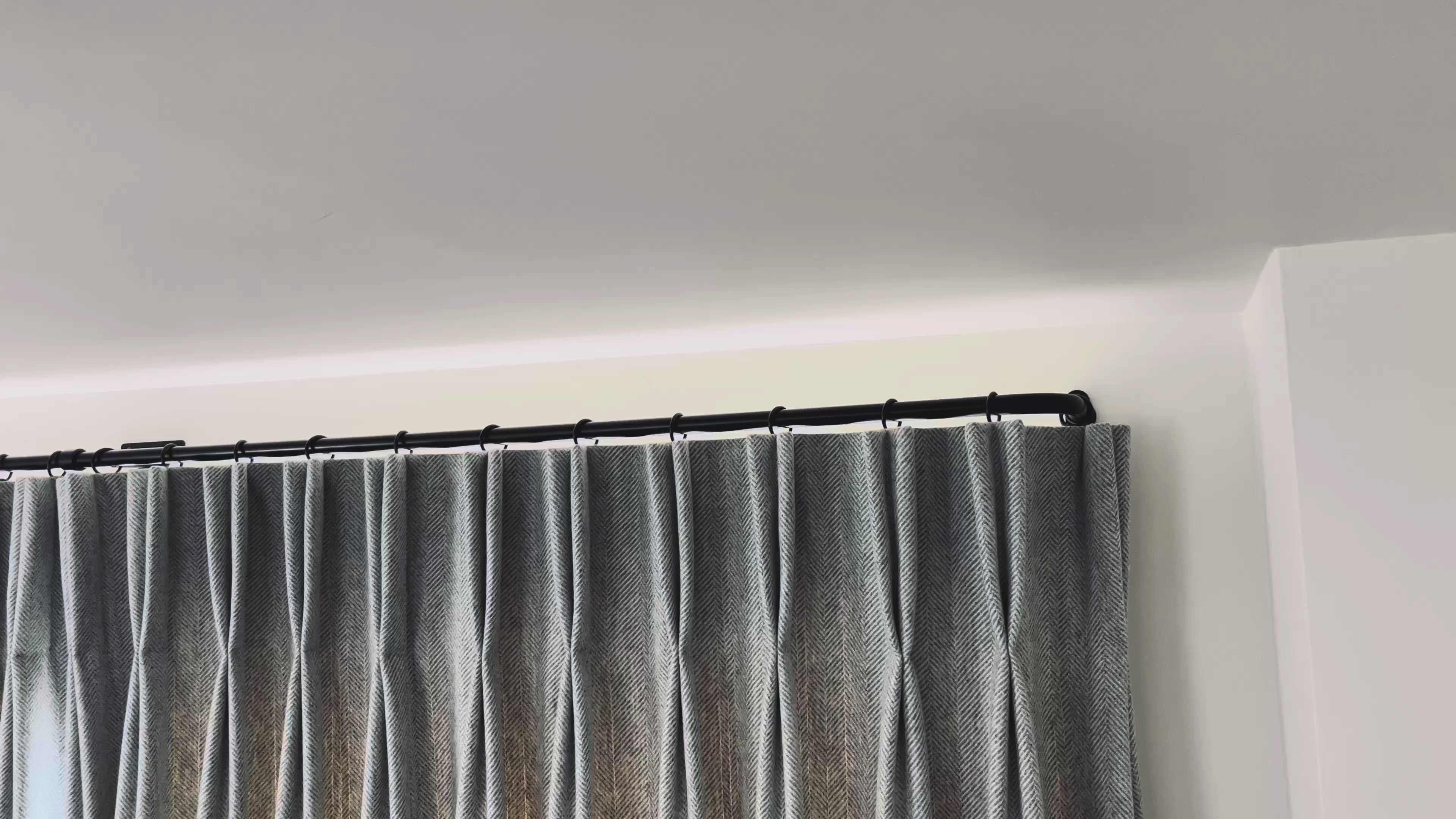 Video of curtains being drawn along a French curtain pole